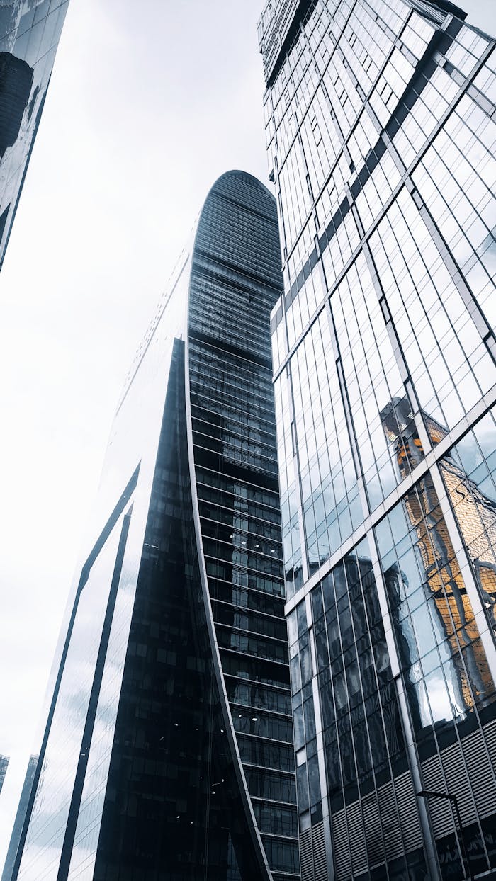 Low angle shot of modern skyscrapers in Moscow, showcasing sleek architectural design and glass facades.